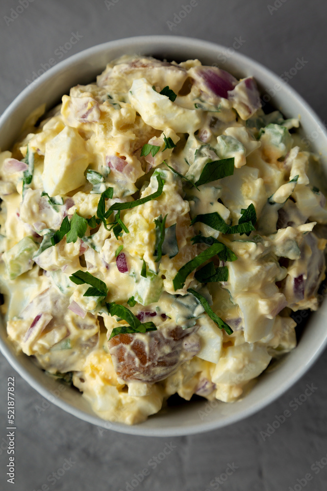 Homemade Healthy Potato Salad with Eggs in a Bowl on a gray background, top view. Flat lay, overhead, from above. Close-up. Homemade Healthy Potato Salad with Eggs in a Bowl on a gray background, top view. Flat lay, overhead, from above. Close-up.