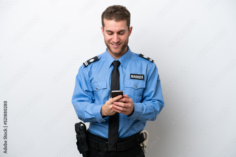 Young police caucasian man isolated on white background sending a message with the mobile