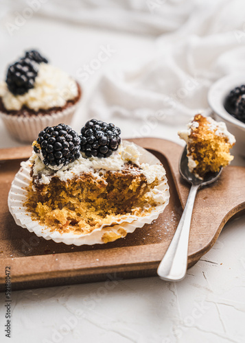 muffin cupcake paper mold carrot cake topped with whipped cream and berries  blackberry