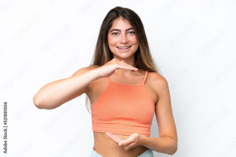 Young caucasian woman isolated on white background holding copyspace imaginary on the palm to insert an ad Young caucasian woman isolated on white background holding copyspace imaginary on the palm to insert an ad