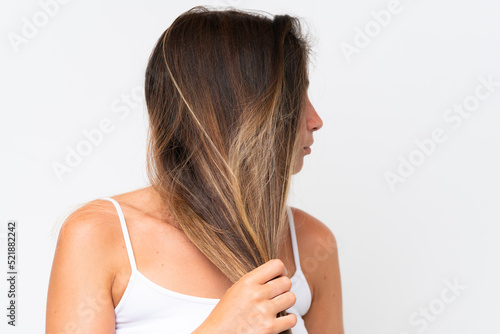 Young Pretty caucasian woman isolated on white background touching her hair. Close up portrait