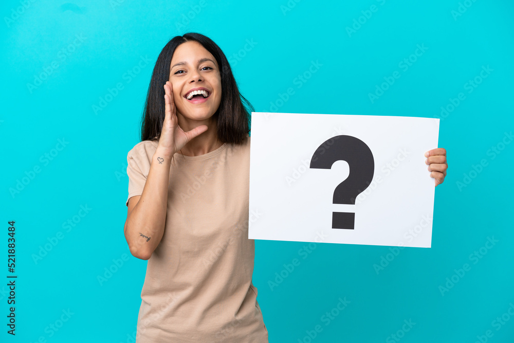 Young woman over isolated background holding a placard with question mark symbol and shouting Young woman over isolated background holding a placard with question mark symbol and shouting