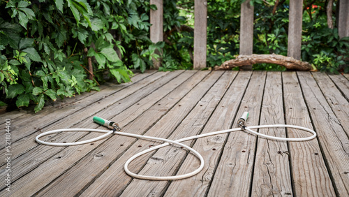 Canvastavla heavy fitness jump rope on rustic, weathered wooden backyard deck