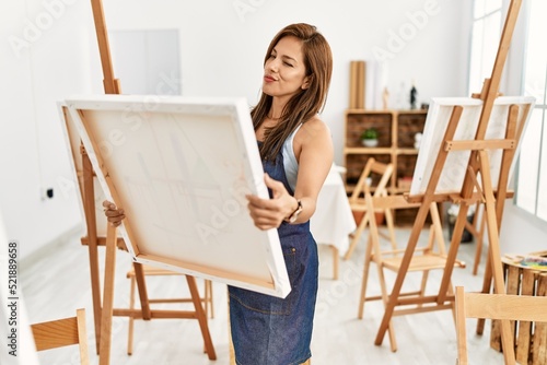 Young hispanic artist woman smiling happy drawing at art studio.