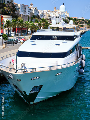 Front view from above of a white yacht moored in the port of Mahon on the island of Menorca, Spain