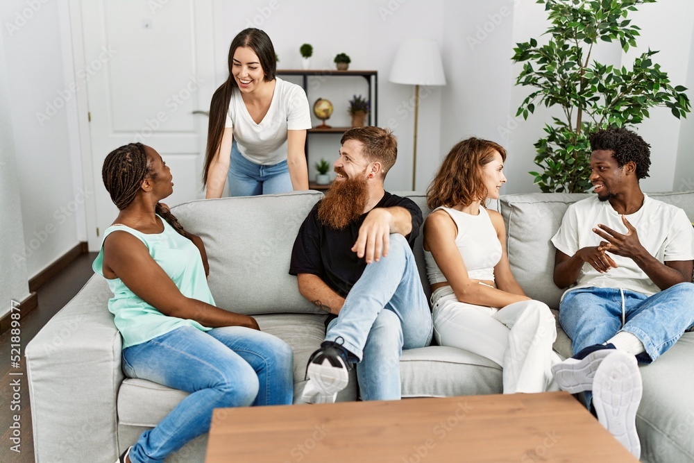 Group of young friends smiling happy sitting on the sofa at home. Group of young friends smiling happy sitting on the sofa at home.