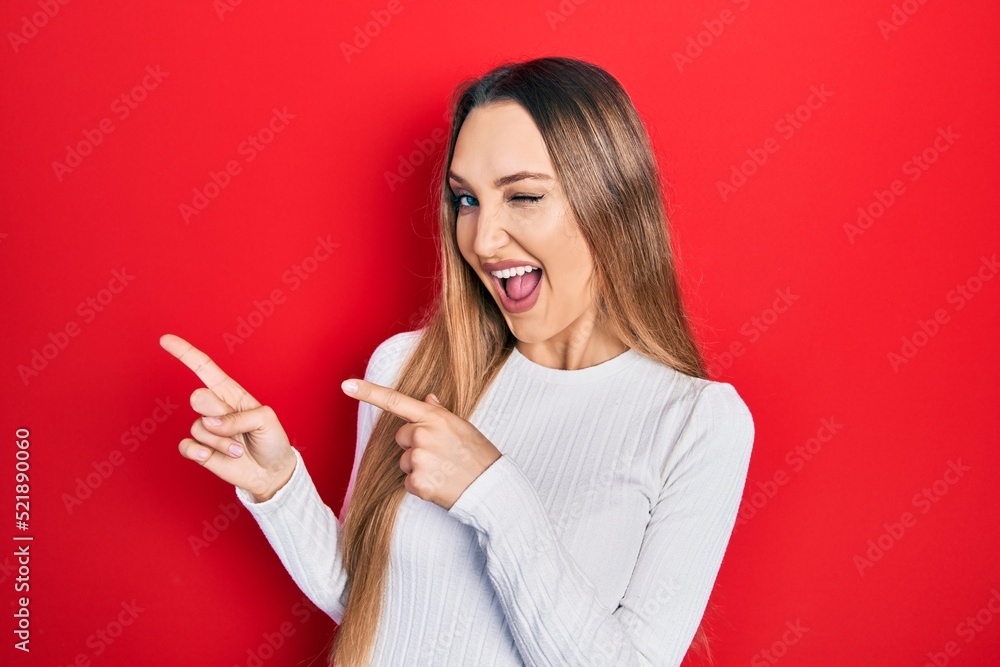 Young blonde girl wearing casual clothes smiling and looking at the camera pointing with two hands and fingers to the side. Young blonde girl wearing casual clothes smiling and looking at the camera pointing with two hands and fingers to the side.