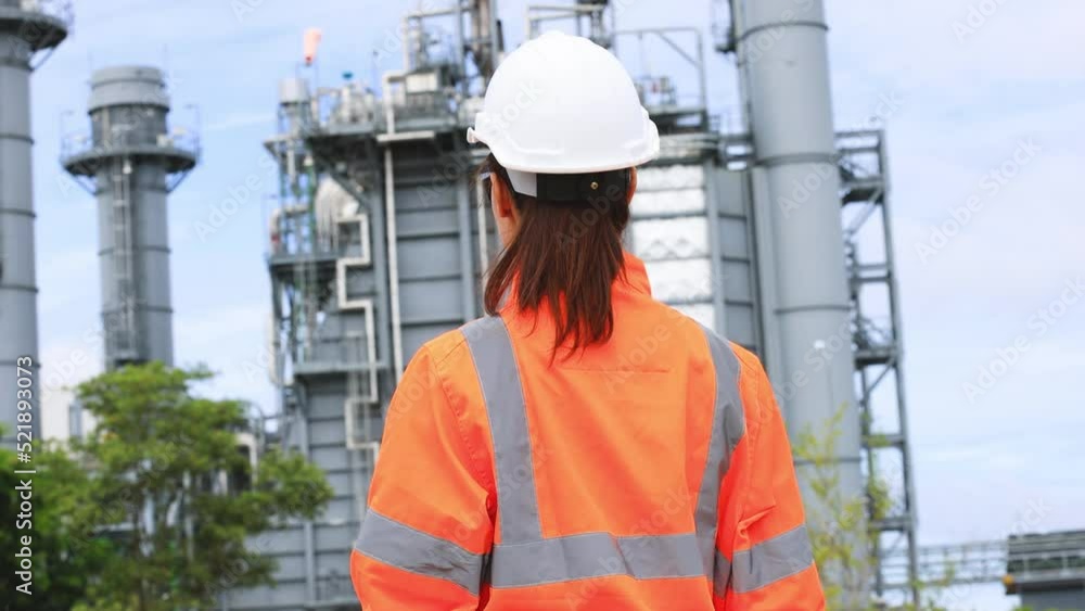 Slow motion Portrait Beautiful next gen female engineer with white safety helmet and orange safety jacket Slow motion Portrait Beautiful next gen female engineer with white safety helmet and orange safety jacket