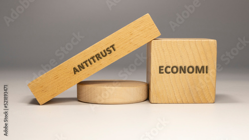 Antitrust written on wooden surface. economy and business. photo