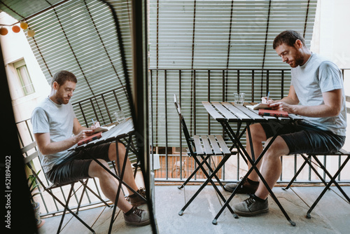 Photography Young redhead man focus on reading a book at home