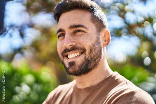 Young hispanic man smiling confident standing at park © Krakenimages.com