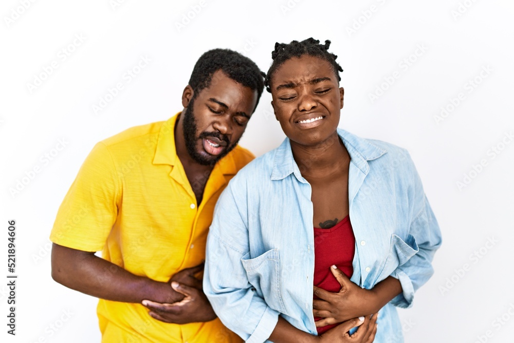 Young african american couple wearing casual clothes with hand on stomach because nausea, painful disease feeling unwell. ache concept. Young african american couple wearing casual clothes with hand on stomach because nausea, painful disease feeling unwell. ache concept.