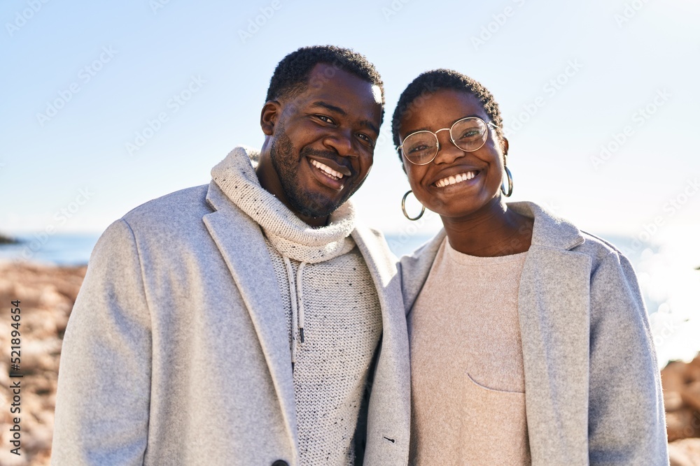 Man and woman couple smiling confident standing together at seaside Man and woman couple smiling confident standing together at seaside