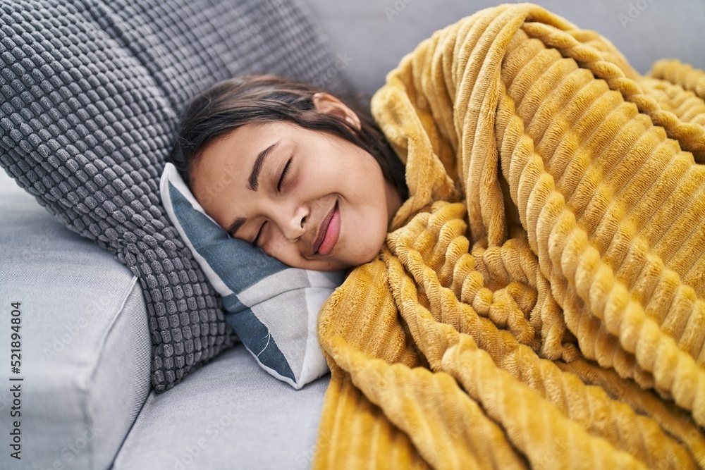 Young african american woman lying on sofa sleeping at home Young african american woman lying on sofa sleeping at home