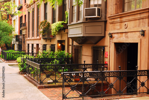 Beautiful historic brownstone residential buildings populate the Gramercy Park neighborhood of New York City.  The residents call the area block beautiful photo