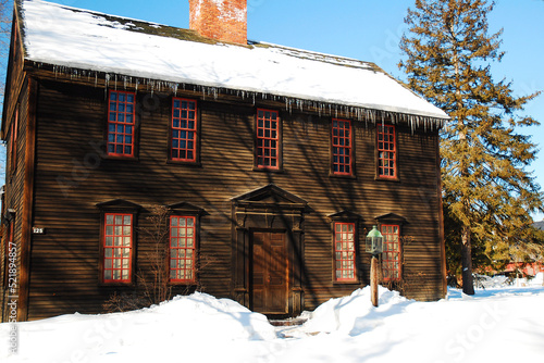 The historic wooden Ashley House, sits under a blanket of snow in Deerfield, MA photo