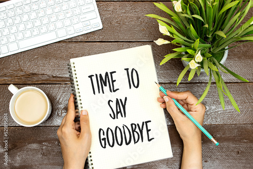 woman writing time to say goodbye concept, desktop keyboard and lilies flowers and cup of coffee