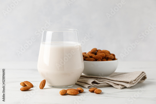 Photos Almond milk in a glass and almond nuts