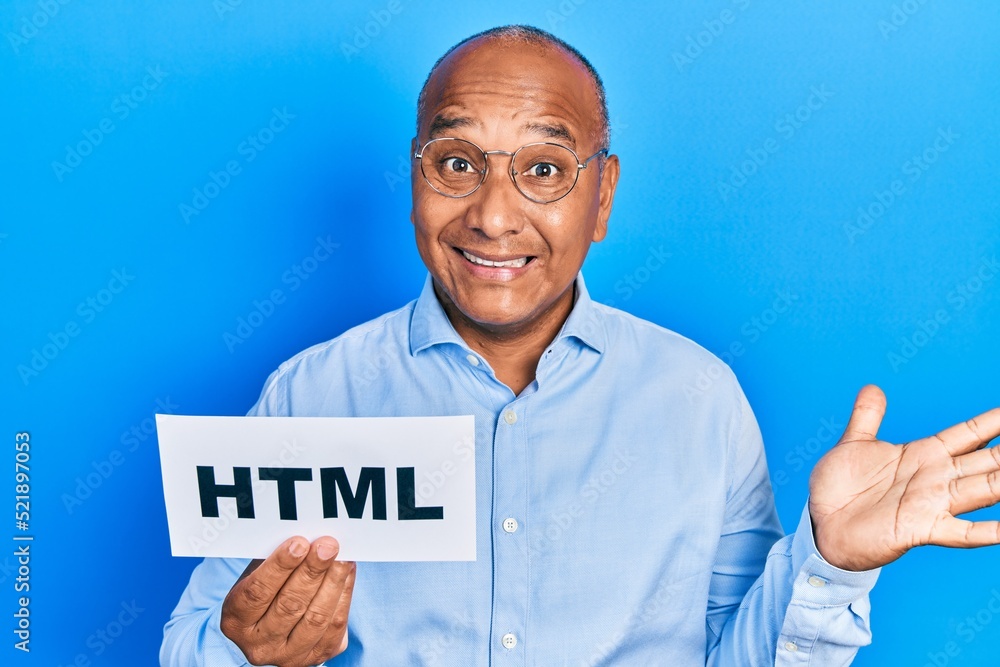 Middle age latin man holding html paper message celebrating achievement with happy smile and winner expression with raised hand Middle age latin man holding html paper message celebrating achievement with happy smile and winner expression with raised hand