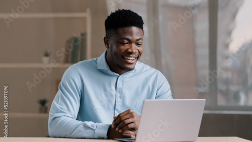 African american businessman young professional worker educator teacher millennial smiling guy talk video call on computer look at webcam online chat with client conduct corporate briefing interview