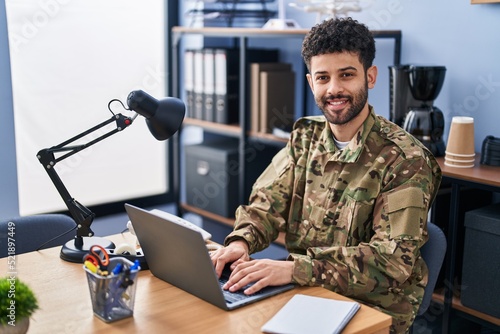 Young arab man army soldier using laptop working at office