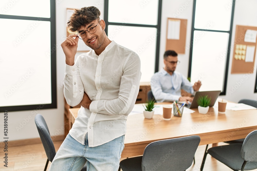 Two hispanic men business workers standing with arms crossed gesture at office Two hispanic men business workers standing with arms crossed gesture at office