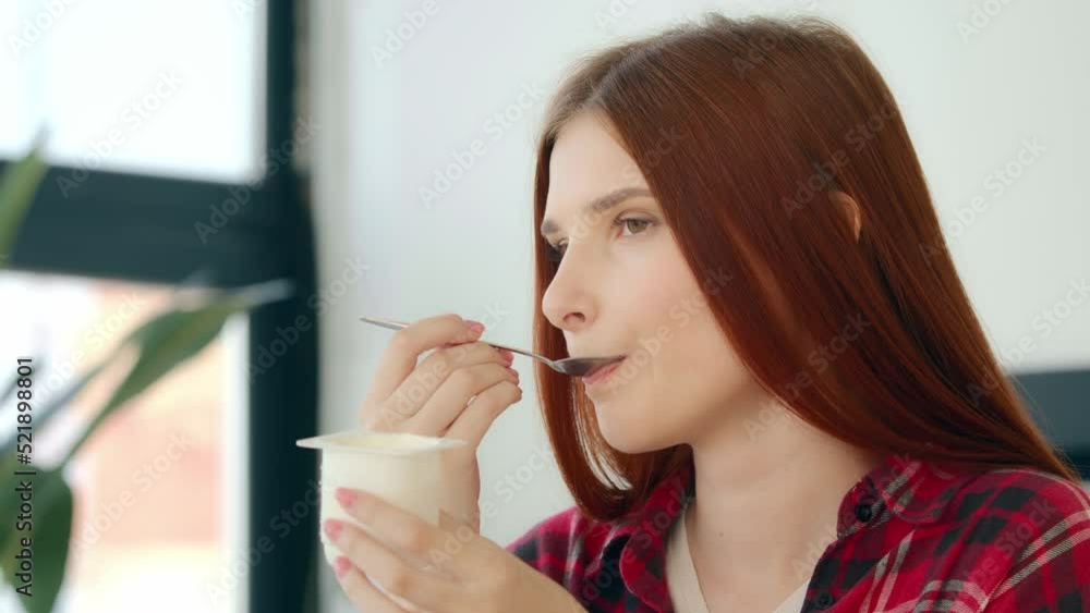 Close up caucasian woman redhead hungry girl vegetarian vegan tasting dairy dessert healthful morning snack delicious breakfast eat creamy yogurt dietary milk product dainty with minimal calorie diet Close up caucasian woman redhead hungry girl vegetarian vegan tasting dairy dessert healthful morning snack delicious breakfast eat creamy yogurt dietary milk product dainty with minimal calorie diet