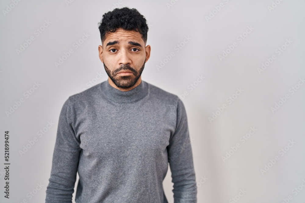 Hispanic man with beard standing over white background depressed and worry for distress, crying angry and afraid. sad expression. Hispanic man with beard standing over white background depressed and worry for distress, crying angry and afraid. sad expression.
