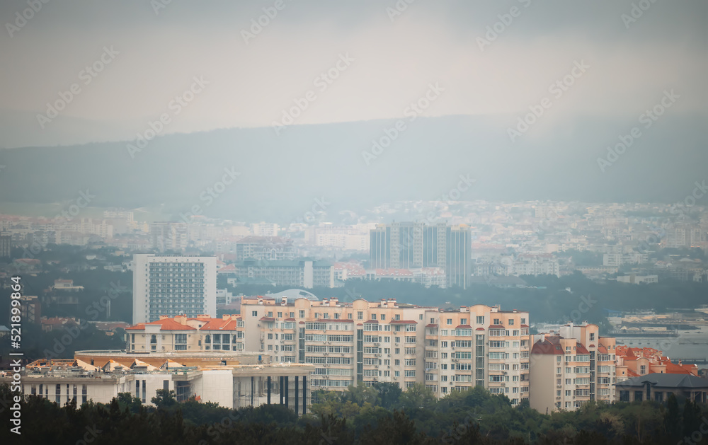Scenic view of mountain town in foggy summer day. Scenic view of mountain town in foggy summer day.