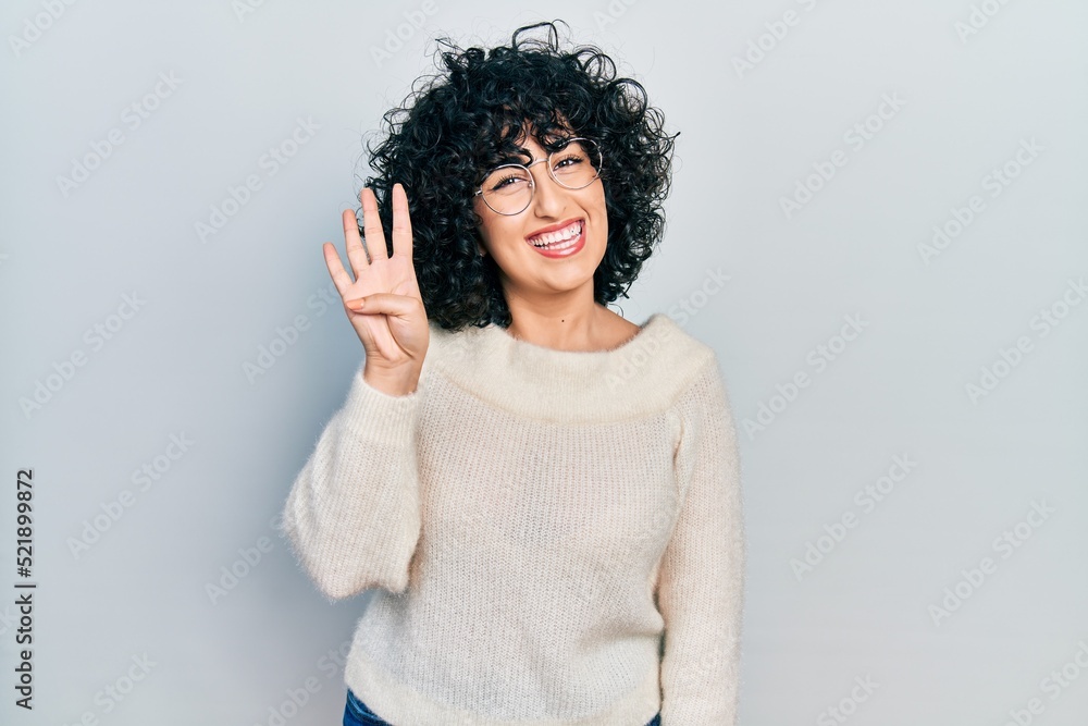 Young middle east woman wearing casual white tshirt showing and pointing up with fingers number four while smiling confident and happy. Young middle east woman wearing casual white tshirt showing and pointing up with fingers number four while smiling confident and happy.