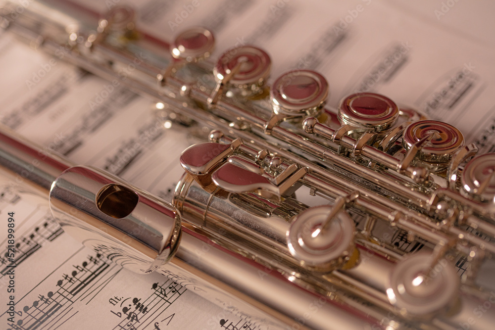 Close up of the flute musical instrument on the music sheet