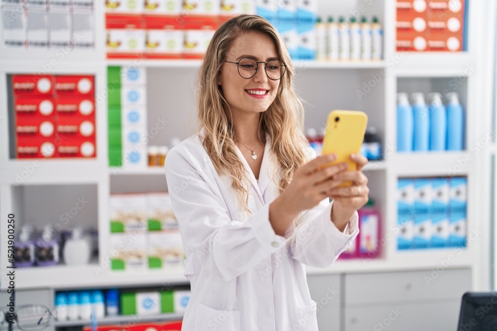 Young woman pharmacist smiling confident using smartphone at pharmacy Young woman pharmacist smiling confident using smartphone at pharmacy