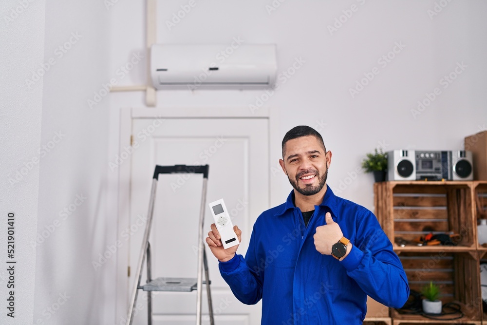 Hispanic repairman working with air conditioner pointing finger to one self smiling happy and proud Hispanic repairman working with air conditioner pointing finger to one self smiling happy and proud