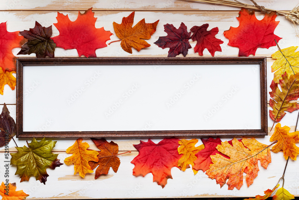 Autumn composition. Thanksgiving holiday concept. Photo frame and autumn leaves.