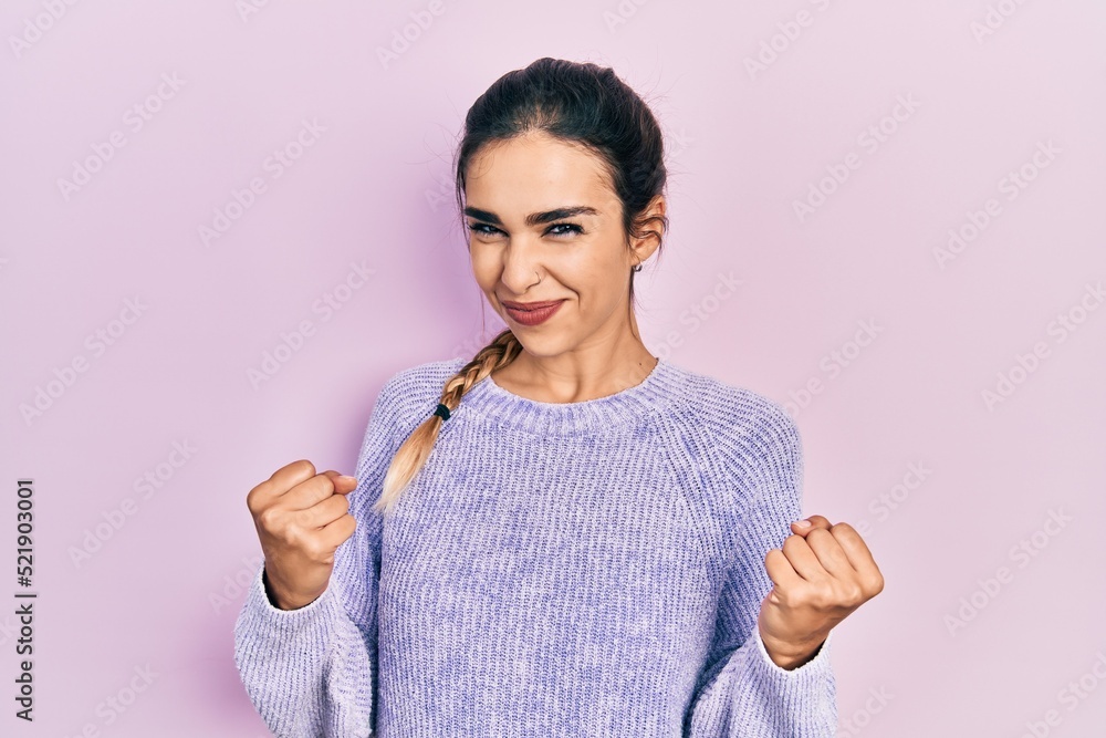 Young hispanic girl wearing casual clothes excited for success with arms raised and eyes closed celebrating victory smiling. winner concept. Young hispanic girl wearing casual clothes excited for success with arms raised and eyes closed celebrating victory smiling. winner concept.
