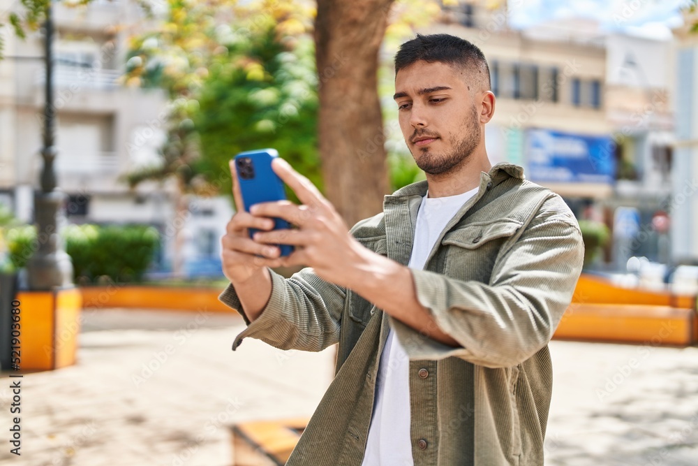 Young hispanic man smiling confident making selfie by the smartphone at park Young hispanic man smiling confident making selfie by the smartphone at park