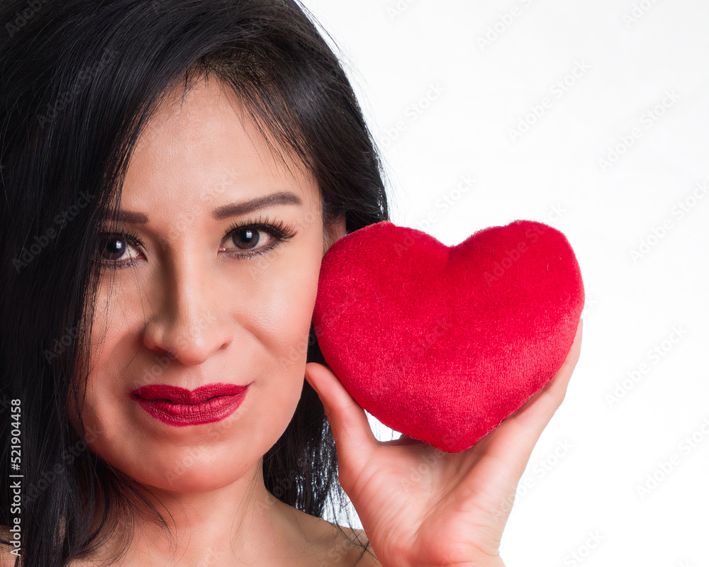 Beautiful and lovely brunette woman smiling with a heart on her hand for Saint Valentine´s Day Beautiful and lovely brunette woman smiling with a heart on her hand for Saint Valentine´s Day