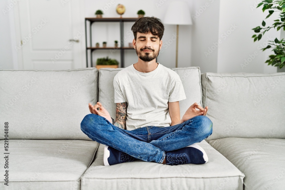 Young hispanic man smiling confident meditating at home Young hispanic man smiling confident meditating at home