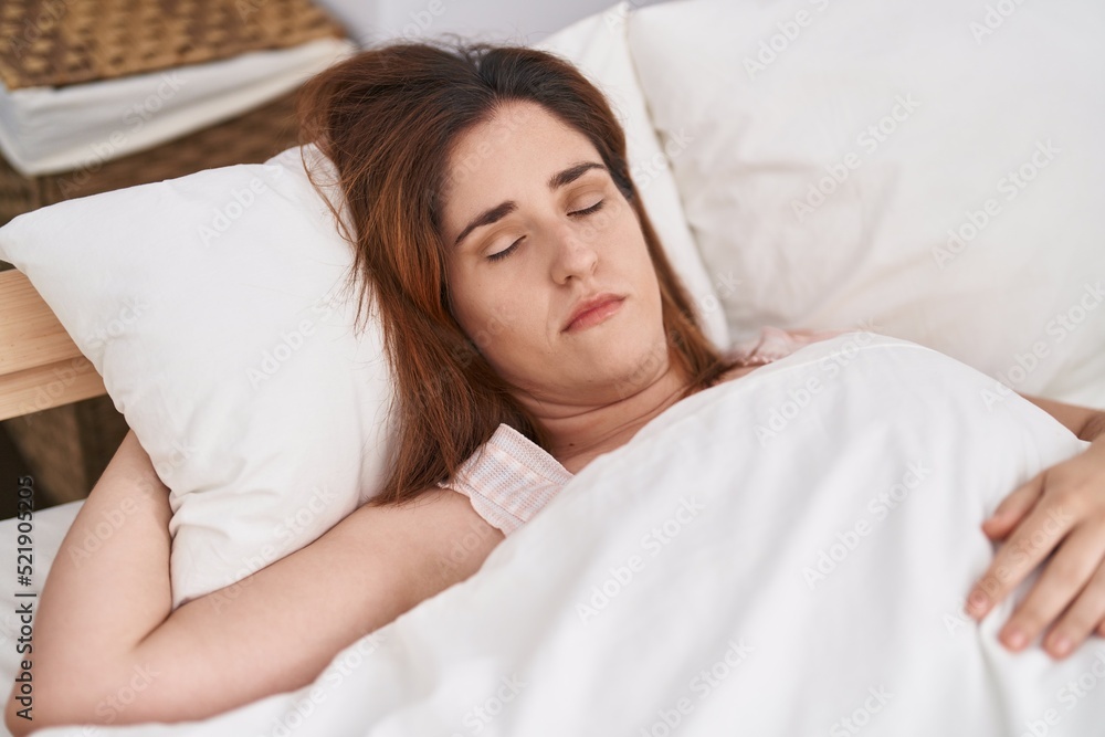 Young woman lying on bed sleeping at bedroom Young woman lying on bed sleeping at bedroom
