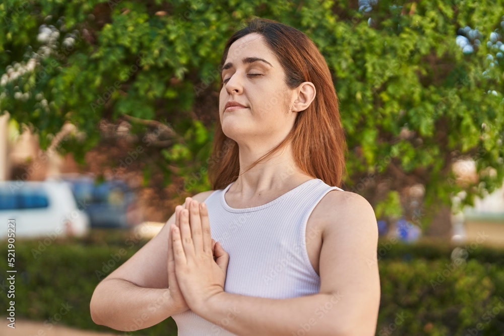 Young woman smiling confident doing yoga exercise at park Young woman smiling confident doing yoga exercise at park