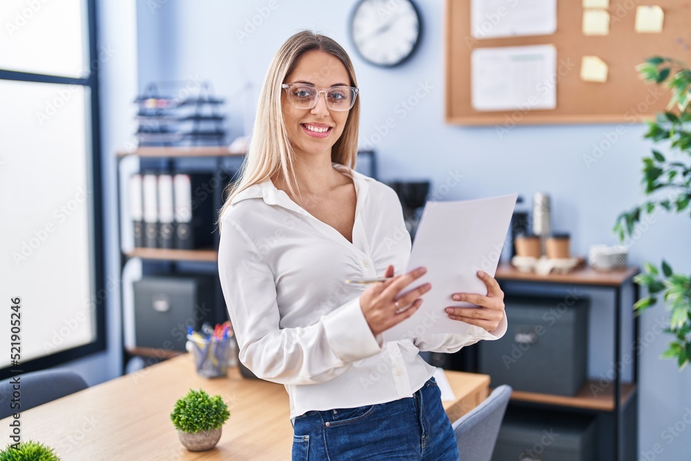 Young woman business worker reading document at office Young woman business worker reading document at office