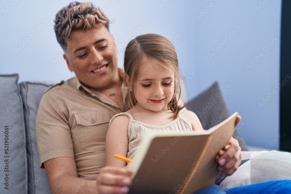 Father and daughter father and daughter writing on notebook at home Father and daughter father and daughter writing on notebook at home