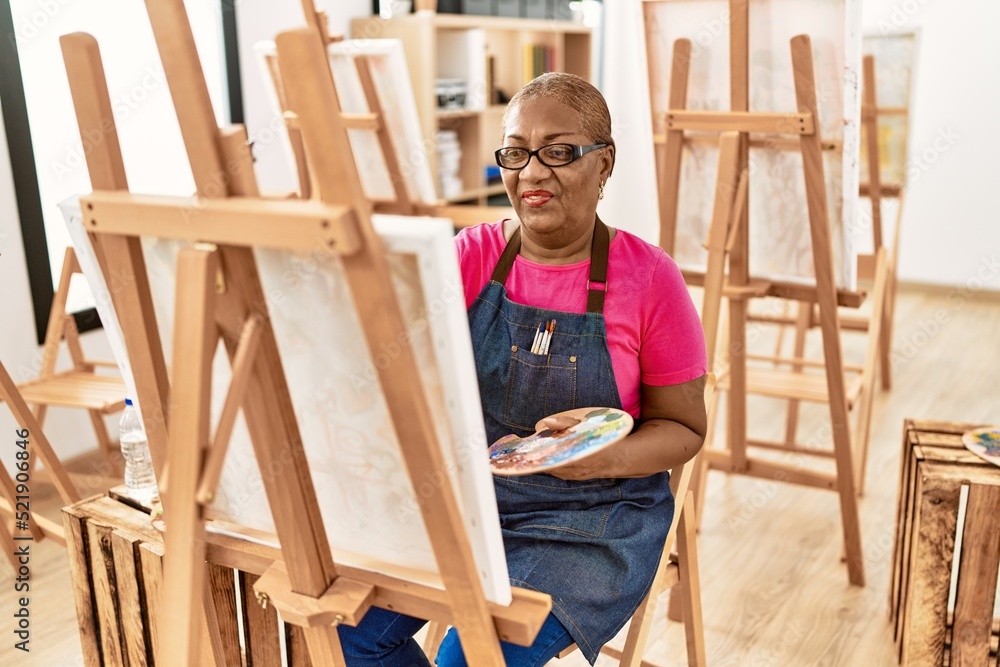 Senior african american woman smiling confident drawing at art studio