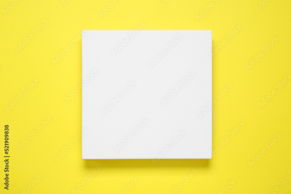Blank canvas on yellow background, top view. Space for design Blank canvas on yellow background, top view. Space for design