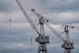 construction cranes of the shipyard on the Neva River in St. Petersburg in cloudy weather