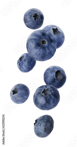 Tasty fresh ripe blueberries falling on white background