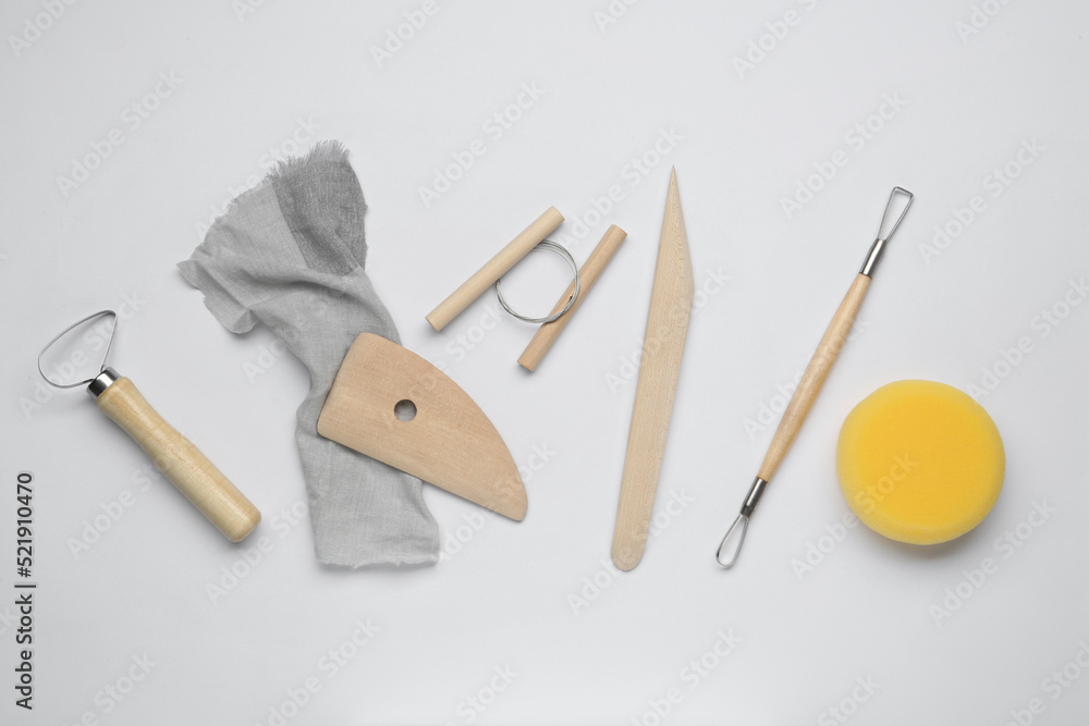Set of clay modeling tools on white background, flat lay Set of clay modeling tools on white background, flat lay