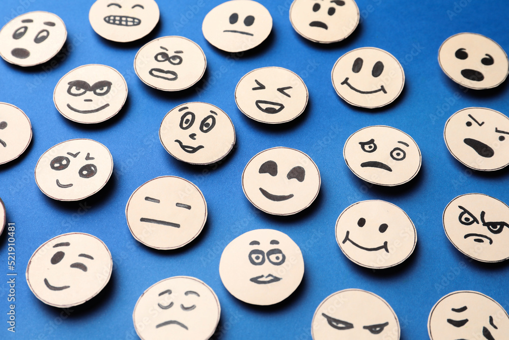 Many faces with different emotions on blue background Many faces with different emotions on blue background