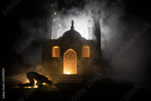 Silhouette of mosque building on toned foggy background. Ramadan Kareem background. Mosque at sunset. Praying people