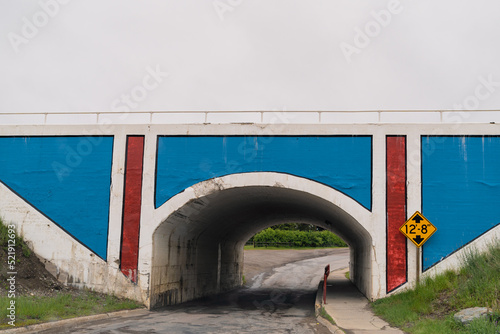 Colorful red, white and blue painted railroad bridge is considered the gateway to Glacier National Park and Blackfeet Indian Country in East Glacier, Montana photo